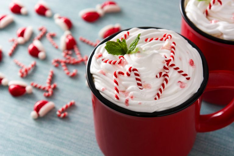 Peppermint coffee mocha for Christmas on blue background